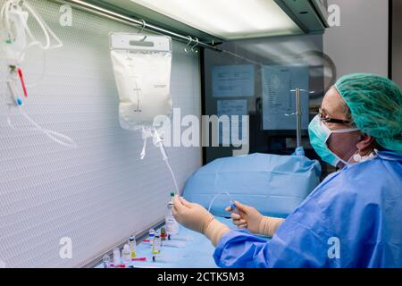 Female doctor holding iv drip in laboratory at hospital Stock Photo