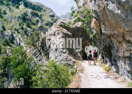 Hikers walking on mountain path at Ruta Del Cares, Asturias, Spain Stock Photo