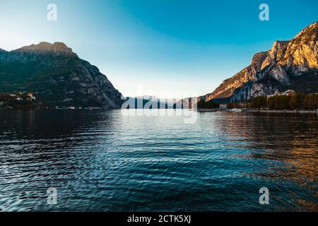 Idyllic scene of Lake Como against clear sky during sunset Stock Photo