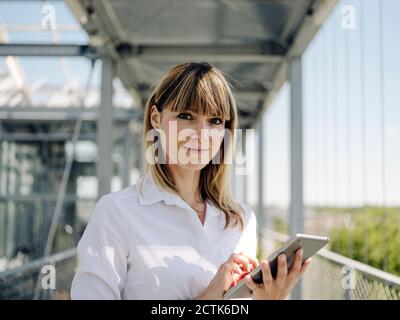 Close-up of confident businesswoman using digital tablet in greenhouse Stock Photo