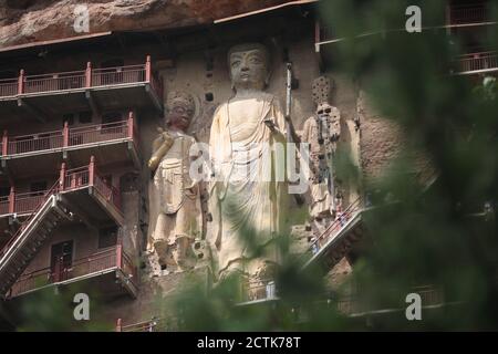 Sculptures of Buddhas are seen on the half of the mountain at the Maijishan Grottoes, a series of 194 caves cut in the side of the hill of Majishan, T Stock Photo