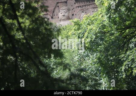 Sculptures of Buddhas are seen on the half of the mountain at the Maijishan Grottoes, a series of 194 caves cut in the side of the hill of Majishan, T Stock Photo