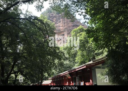 Sculptures of Buddhas are seen on the half of the mountain at the Maijishan Grottoes, a series of 194 caves cut in the side of the hill of Majishan, T Stock Photo