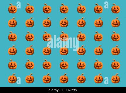 Halloween pumpkins pattern isolated on a blue background Stock Photo