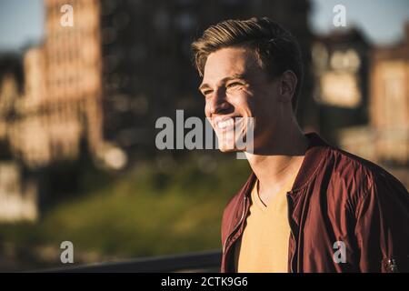 Smiling young man looking away Stock Photo