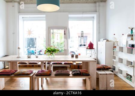 Dining table in bright room with large windows Stock Photo