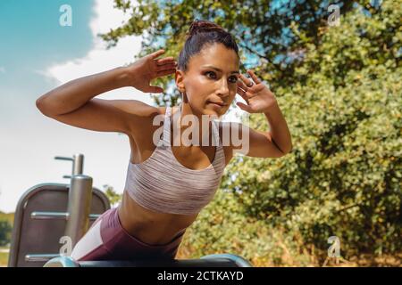 Woman doing push-ups on a fitness trail Stock Photo