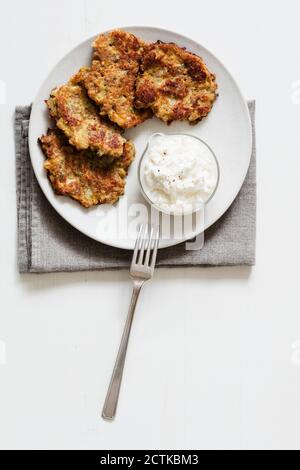 Studio shot of rye and turnip pancakes with sour cream-yogurt dipping sauce Stock Photo