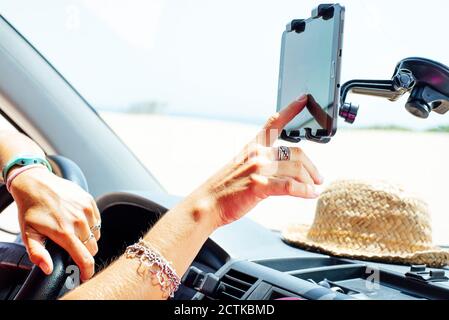 Close-up of woman using navigation on smart phone in van Stock Photo