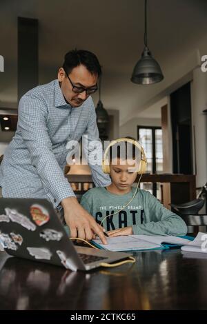 Fatherc helping son with his homework Stock Photo
