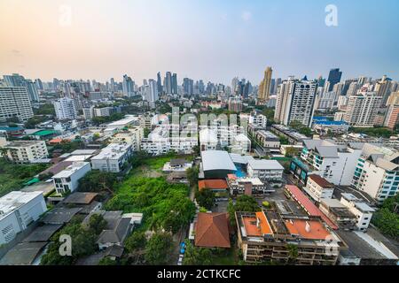 Thailand, Bangkok, Aerial view of residential district with downtown skyscrapers in background Stock Photo