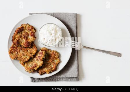 Studio shot of rye and turnip pancakes with sour cream-yogurt dipping sauce Stock Photo