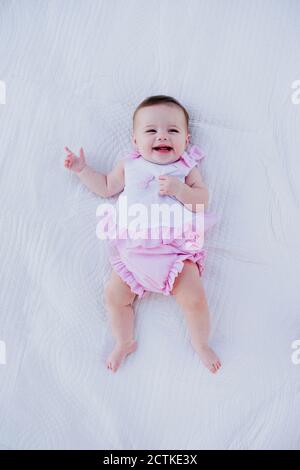 baby girl lying on a white background Stock Photo - Alamy