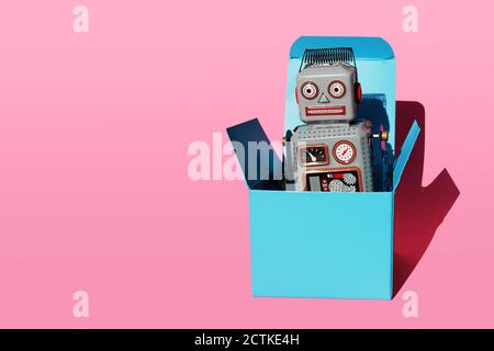 Studio shot of vintage robot toy in turquoise gift box Stock Photo