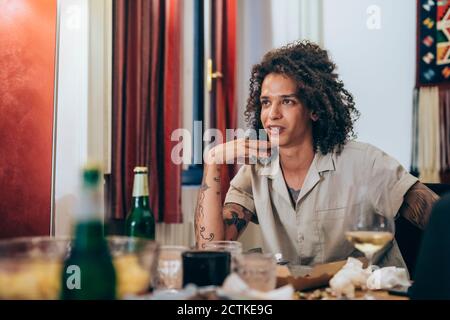 Man looking away while sitting at table during party Stock Photo