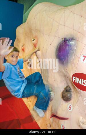 Huntsville Alabama,Sci-Quest Hands-on Science Center,inside interior climbing wall,boy climbs Stock Photo