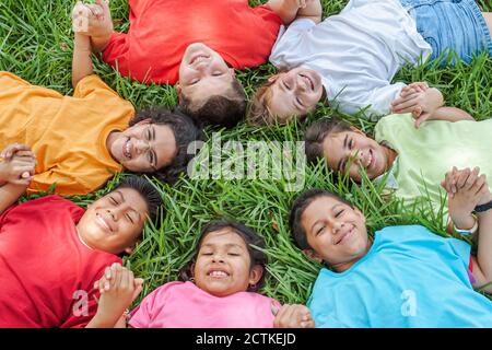 Miami Florida,Non Violence Project USA,teaching student students non violent behavior,boys boy girl girlss smiles smiling,hold holding hand hands circ Stock Photo