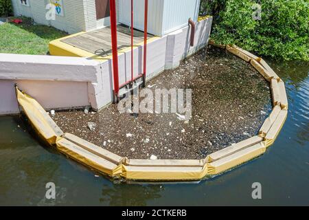 Florida Ft. Fort Lauderdale pollution trash litter,polluted water canal pumping station floating containment barrier, Stock Photo