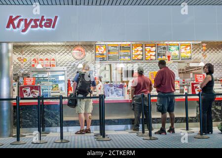 Georgia Atlanta Hartsfield International Airport,inside interior terminal gate,Krystal hamburger fast food restaurant counter customers,line queue buy Stock Photo