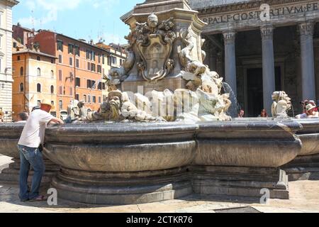 Rome, Lazio region, Italy.  Fountain outside of the Pantheon, or Fontana del Pantheon, and is surmounted by an Egyptian obelisk. (For editorial use on Stock Photo