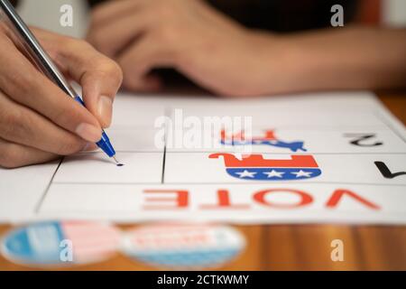 Maski, India 20, September 2020 : Close up of hands voting by selecting the political party at polling booth - Concept of polling at US election.