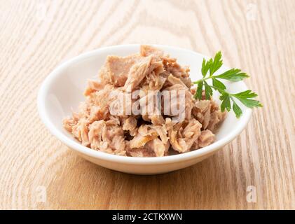 Tuna and Italian parsley on a wooden background Stock Photo
