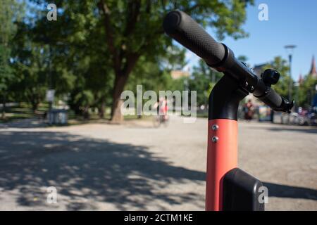 Tampere, Finland - JULY 26, 2019. A silhouette of an alone female bicyclist riding a bike in the public park on a sunny summer day. Stock Photo