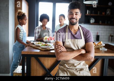 Happy family preparing together food in the kitchen Stock Photo