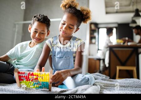 Children, education, plyaing happiness concept. Happy kids entertaining themselves at home Stock Photo