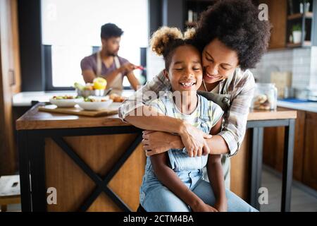 Happy family preparing healthy food in kitchen together Stock Photo