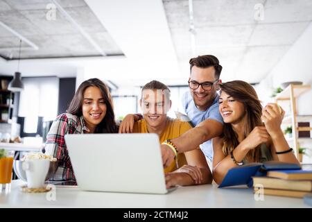 Multiracial young people enjoying group study at table. Stock Photo