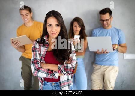 Happy young people working, using digital devices. Technology, people concept. Stock Photo
