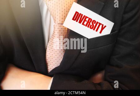 Diversity word on a card in businessman pocket. Tolerance and equality in business team. Social and business concept Stock Photo