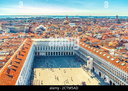 Aerial panoramic view of Venice city old historical centre, buildings with red tiled roofs, Procuratie on Piazza San Marco or St Mark Square, Veneto Region, Northern Italy. Amazing Venice cityscape. Stock Photo
