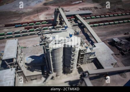 Mynaral/Kazakhstan - April 23 2012: Modern cement plant in desert. Cement silos. Cargo railroad terminal. Railway carriages on track. Stock Photo