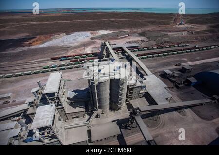 Mynaral/Kazakhstan - April 23 2012: Modern cement plant in desert. Cement silos. Cargo railroad terminal. Railway carriages on track. Stock Photo