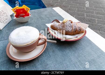 Cup of cappuccino and croissant served in a cafe, Atrani, Amalfi coast, Campania, Italy Stock Photo
