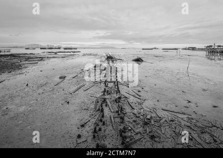 View of remains of the old pier at low tide, Tan Jetty, George Town, Penang, Malaysia. Black and white photography for printing. Stock Photo