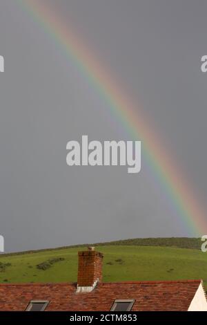 Llanrhystud, Ceredigion, Wales, UK. 24th September 2020 UK Weather: Sunshine and showers, with a bright rainbow above the village of Llanrhystud in mid Wales. © Ian Jones/Alamy Live News Stock Photo