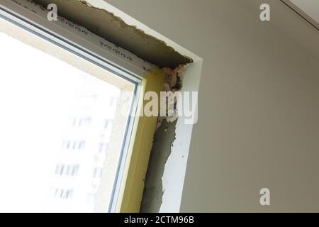Repair in the slopes of the window. The process of applying a layer of plaster on the sides of the window. Stock Photo