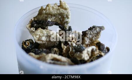 Fish skin crackers on white background. Made from patin fish. Stock Photo