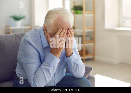 Elderly man, grieving about death of relative or forgotten by family, crying alone Stock Photo