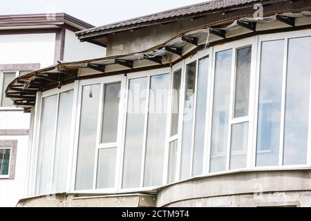 two white plastic windows in a brick wall outside Stock Photo