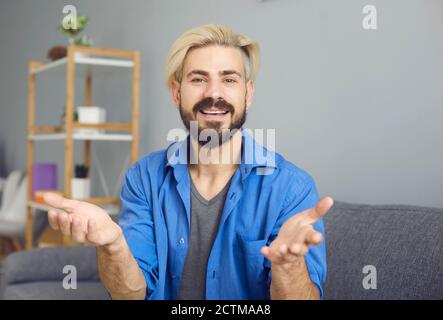 Guy looking at the camera online talks at a meeting training education video chat webinar call application. Stock Photo