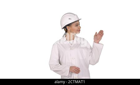 Mature engineer woman in hard hat indicating to the product or t Stock Photo