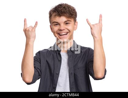 Portrait of handsome teen boy making Rock Gesture. Happy cute child isolated on white background. Stock Photo