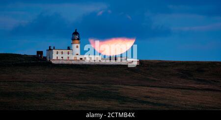 Copinsay lighthouse with partial full moon, Orkney Isles Stock Photo