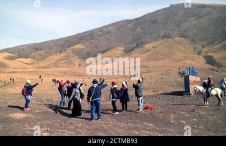 Probolinggo, Indonesia - October 27, 2019: Visitors enjoy the view at Teletubies Hill on Mount Bromo in East Java. Stock Photo