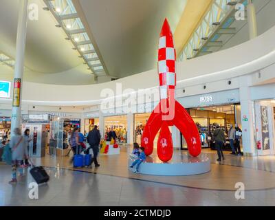 Brussels, Belgium - August 2018: People in the duty-free shopping area with the large Tin Tin rocket in the middle at Brussels Airport terminal A Stock Photo
