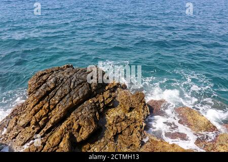 Picturesque view to the rock and azure sea water. Waves break on the stones of the coast, rocky beach for background Stock Photo
